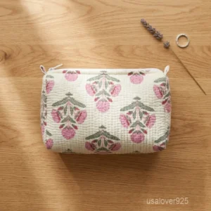 A three-piece nesting set of White Block Print Quilted Cotton Toiletry Bags neatly arranged on a clean vanity counter showing the large, medium, and small size profiles.