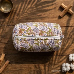 A three-piece nesting set of White Floral Quilted Cotton Toiletry Bags neatly arranged on a clean vanity counter showing the large, medium, and small size profiles.