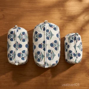 Close-up of the handcrafted white floral print detailing, dense vertical quilted stitching rows, waterproof internal plastic lining, and built-in inside slots on an Indian cotton cosmetic caddy pouch.