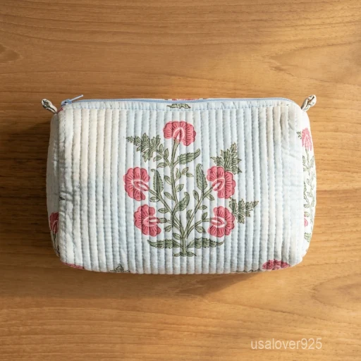 A three-piece nesting set of White Flower Print Quilted Cotton Toiletry Bags neatly arranged on a clean vanity counter showing the large, medium, and small size profiles.