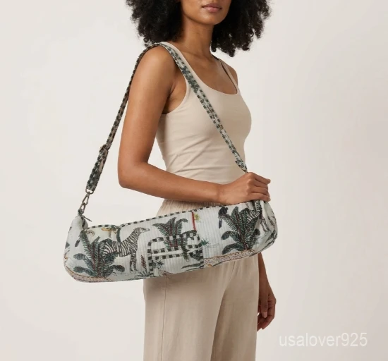 Close-up of the handcrafted white jungle print detailing, dense quilted stitching texture lines, robust adjustable strap attachments, and clean zip track on an Indian cotton Pilates carrier bag.