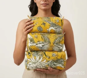 Close-up of the handcrafted yellow block print detailing, dense horizontal quilted stitching rows, waterproof internal plastic lining, elegant beads, and handcrafted tassel on an Indian cotton cosmetic pouch caddy.