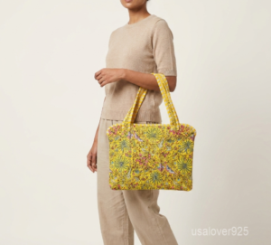 Yellow Floral Botanical Laptop Sleeve showing the traditional hand block print artisan design with the smooth zipper closure and double carry handles.
