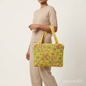 Yellow Floral Botanical Laptop Sleeve showing the traditional hand block print artisan design with the smooth zipper closure and double carry handles.