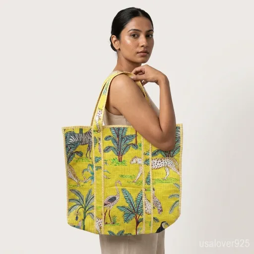 Yellow Jungle Print Quilted Cotton Tote Bag with comfortable over-the-shoulder handles held against a natural background.