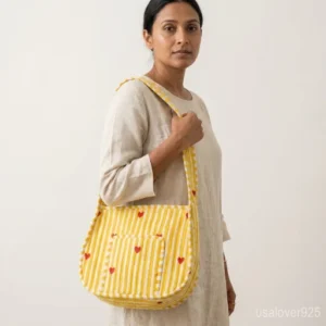 Close-up of the secure top zipper closure, generous 5-inch gusset, and premium quilted stitching on a yellow cotton purse.