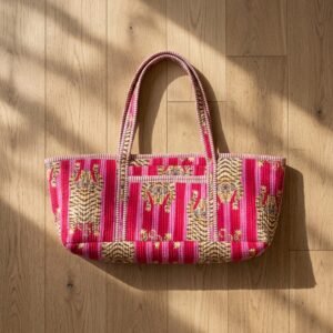 Close-up of the handcrafted pink wild cat stripe print detailing, dense quilted stitching texture lines, robust handle strap attachments, and spacious open layout on an Indian cotton Pilates carrier bag.