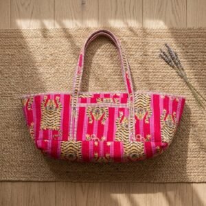 A fitness enthusiast carrying the Pink Tiger Quilted Yoga Tote Bag over the shoulder by the wide straps, showcasing its long profile and classic bohemian accessory style while heading to a gym class.