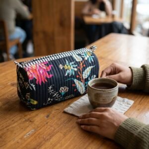 Black Chintz Quilted Toiletry Bag Set showing the nested 3-piece handmade travel pouch bundle with the traditional chintz floral hand block print design and secure zipper tracks.