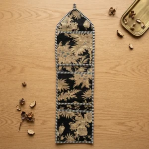 Close-up of the handcrafted vintage botanical print detailing, dense quilted stitching texture lines, robust pocket seam attachments, and clean pocket opening on the cotton pocket storage.