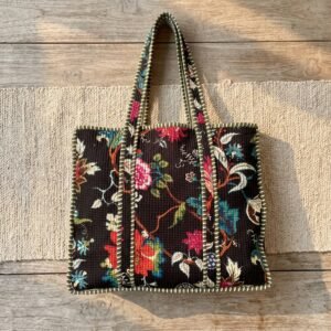 Close-up of the largest case in the Black Floral Quilted Tote Bag Set opened to reveal the clean protective interior lining, smooth zipper track, and soft quilted horizontal stitching texture.