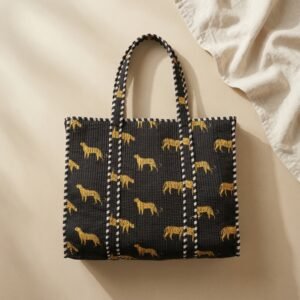 Close-up of the handcrafted black jungle print detailing, dense quilted stitching texture lines, robust handle strap attachments, and clean inner layout on an Indian cotton travel purse.