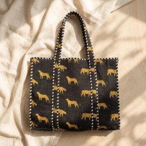 Close-up of the handcrafted black jungle print detailing, dense quilted stitching texture lines, robust handle strap attachments, and clean inner layout on an Indian cotton travel purse.