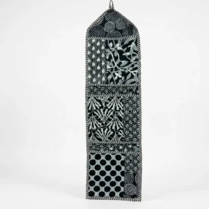 Close-up of the handcrafted black geometric print detailing, dense quilted stitching texture lines, robust pocket seam attachments, and clean pocket opening on the cotton pocket storage.