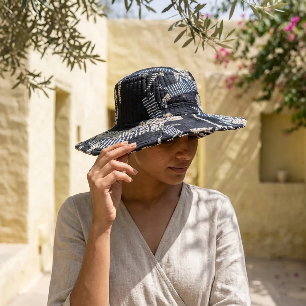 Black Safari Quilted Cotton Sun Hat showing the wide brim bucket cap frame with the handcrafted black wild cat block print detailing.