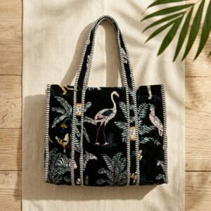Close-up of the handcrafted black jungle print detailing, dense quilted stitching texture lines, robust handle strap attachments, and clean inner layout on an Indian cotton travel purse.