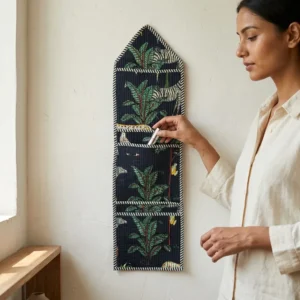 Black Safari Quilted Wall Hanging Organizer displaying the multi-pocket vertical sorting slots with the traditional tiger print artisan design hung securely on an entryway wall.