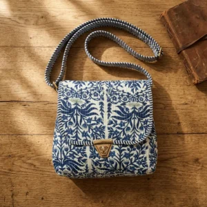 Close-up of the handcrafted blue botanical print detailing, dense quilted tracking lines, robust zipper closure, and clean seam line on the block print travel handbag.