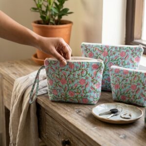 A traveler organizing their vanity case with the Blue Floral Quilted Makeup Bag Set, showcasing its generous packing capacity and elegant patterned cosmetic travel organizer style.
