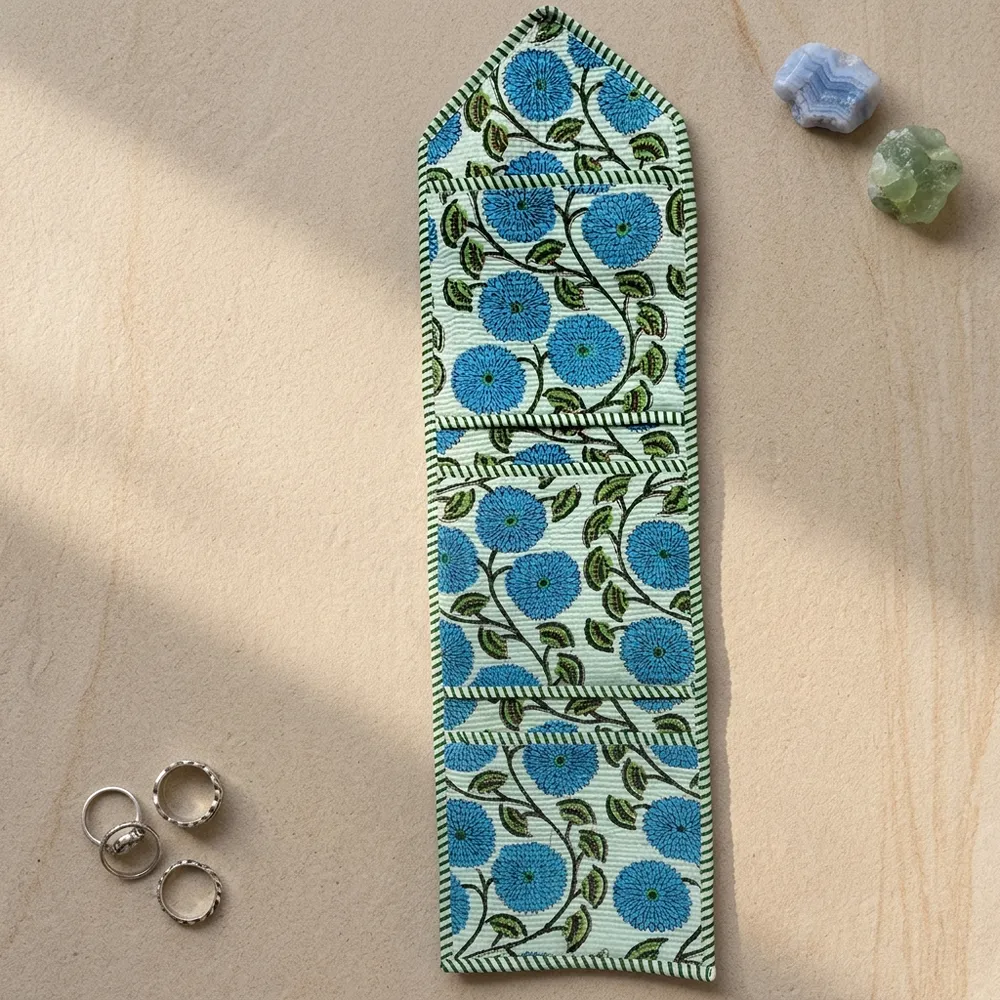 Close-up of the handcrafted blue botanical print detailing, dense quilted stitching texture lines, robust pocket seam attachments, and clean pocket opening on the cotton pocket storage.