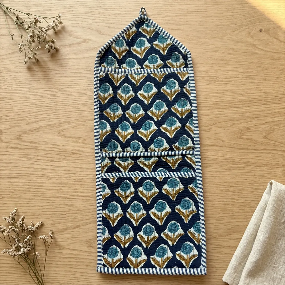 Close-up of the handcrafted indigo geometric print detailing, dense quilted stitching texture lines, robust pocket seam attachments, and clean pocket opening on the cotton pocket storage.