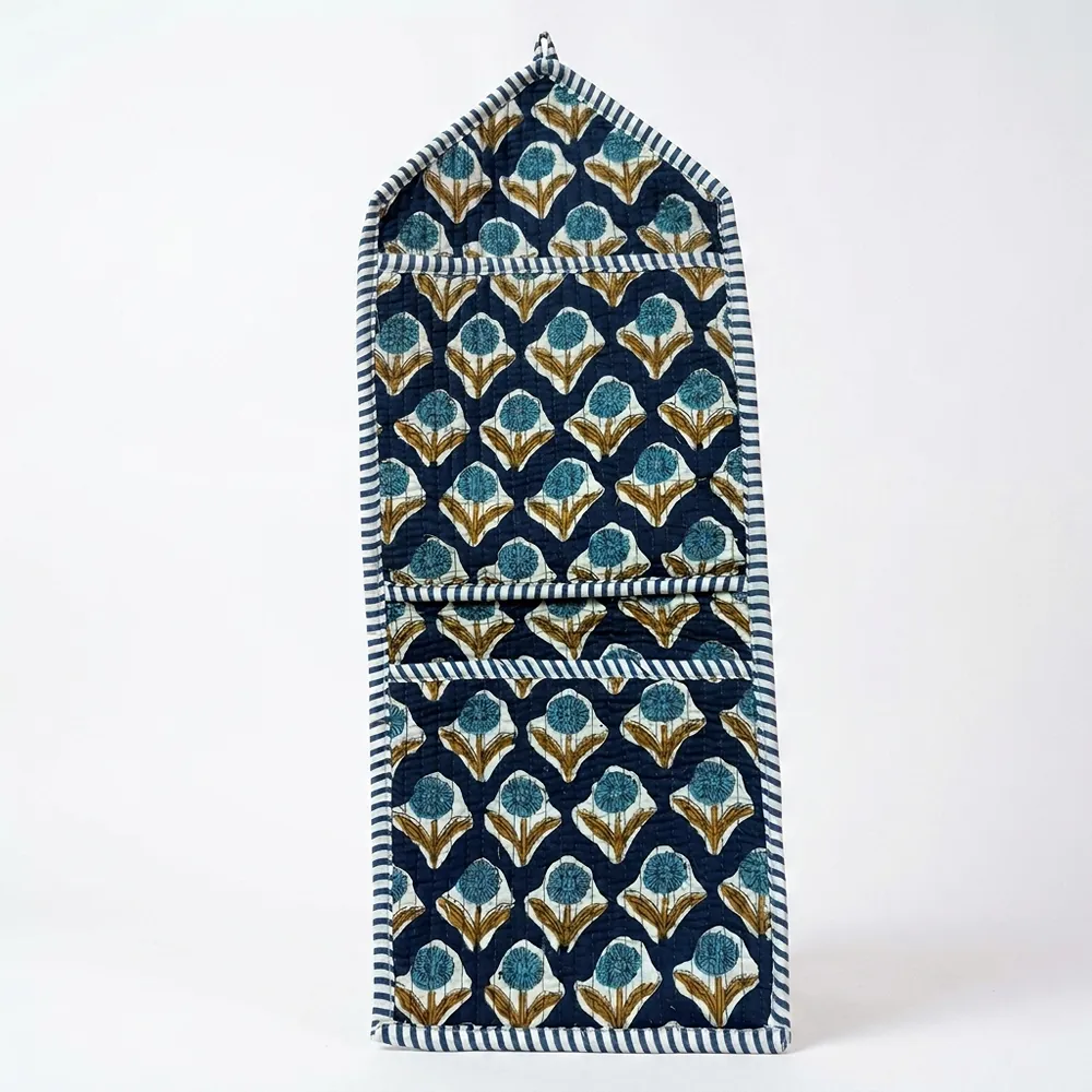 Close-up of the handcrafted indigo geometric print detailing, dense quilted stitching texture lines, robust pocket seam attachments, and clean pocket opening on the cotton pocket storage.