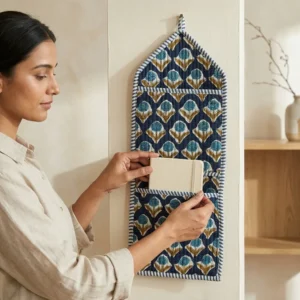 Blue Indigo Quilted Wall Hanging Organizer displaying the multi-pocket vertical sorting slots with the traditional indigo block print artisan design hung securely on an entryway wall.