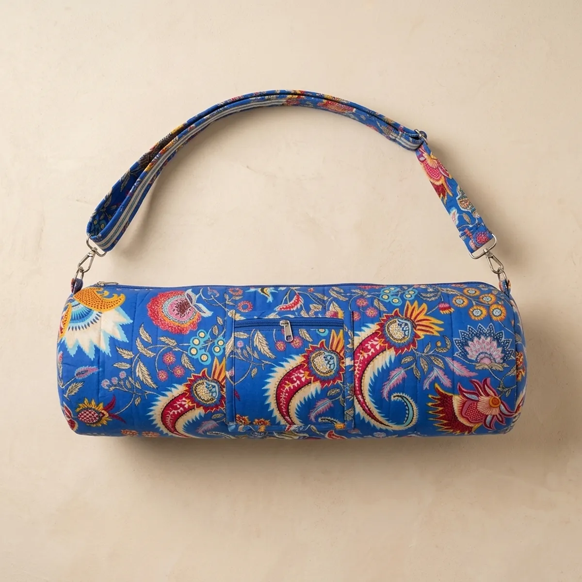 Close-up of the handcrafted multicolored floral detailing, dense quilted tracking lines, robust zipper attachment, and durable cross-stitched shoulder strap joints on the fitness tote.