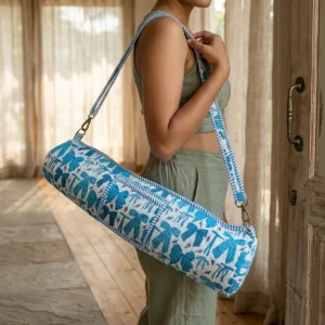 Blue Ribbon Quilted Cotton Yoga Mat Bag showing the cylindrical crossbody carrier design with the handcrafted blue ribbon block print pattern and full-length zipper closure.