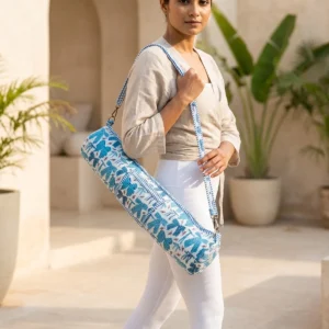 Blue Ribbon Quilted Cotton Yoga Mat Bag showing the cylindrical crossbody carrier design with the handcrafted blue ribbon block print pattern and full-length zipper closure.