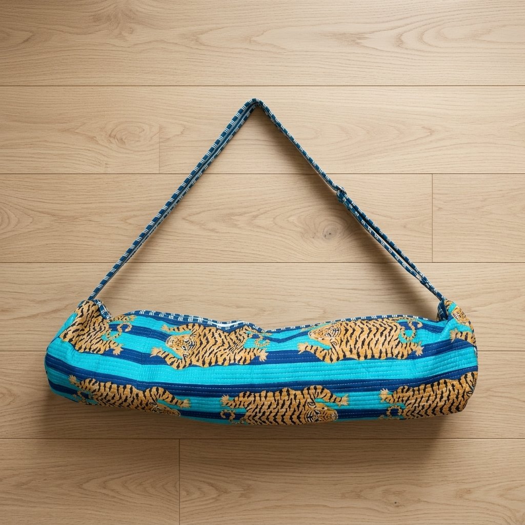 Close-up of the handcrafted blue wild cat stripe print detailing, dense quilted stitching texture lines, robust handle strap attachments, and secure opening layout on an Indian cotton Pilates carrier bag.