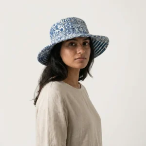 Close-up of the handcrafted blue geometric print detailing, dense quilted tracking stitching lines, and neat edge trim on the reversible side of the summer travel headwear.