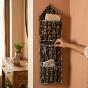 Floral Fabric Wall Hanging Organizer displaying the 3-pocket vertical sorting slots with the traditional block print artisan design hung securely on an entryway wall.