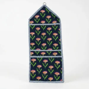 Close-up of the handcrafted floral print detailing, dense quilted stitching texture lines, robust pocket seam attachments, and clean pocket opening on the cotton pocket storage.