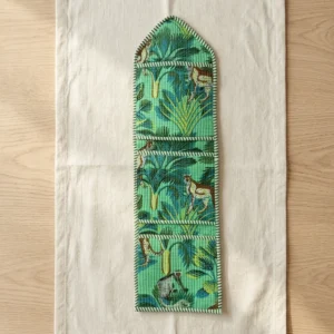 Close-up of the handcrafted jungle print detailing, dense quilted stitching texture lines, robust pocket seam attachments, and clean pocket opening on the cotton pocket storage.