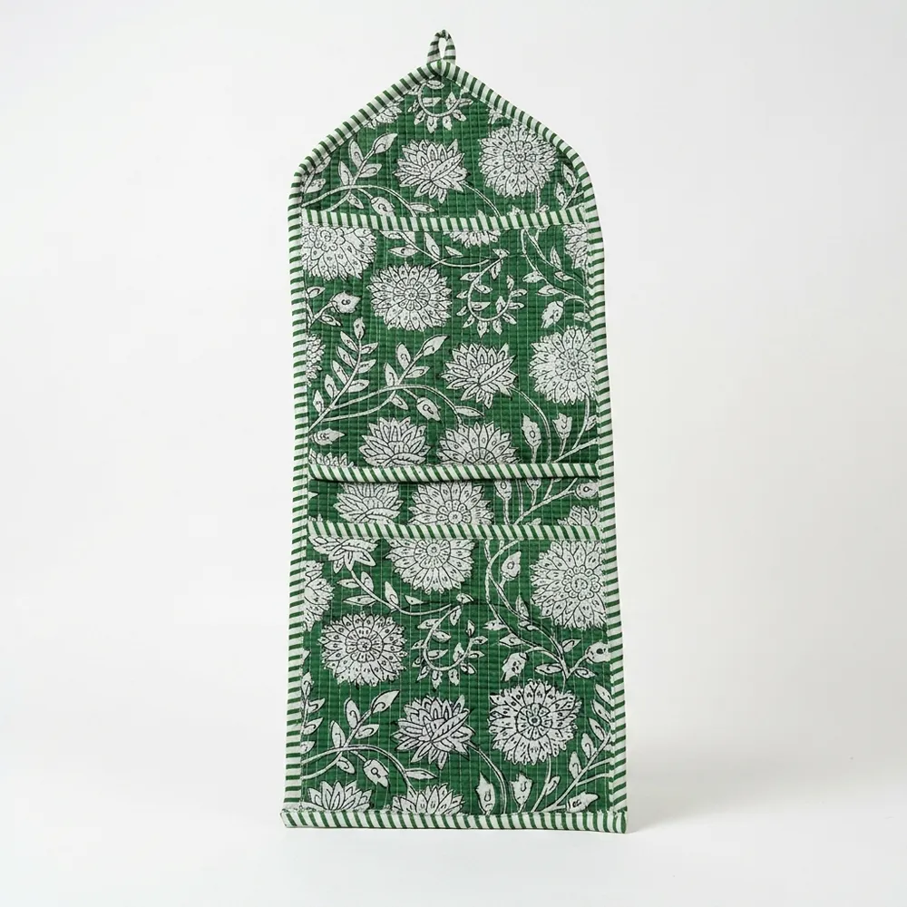 Close-up of the handcrafted green botanical print detailing, dense quilted stitching texture lines, robust pocket seam attachments, and clean pocket opening on the cotton pocket storage.