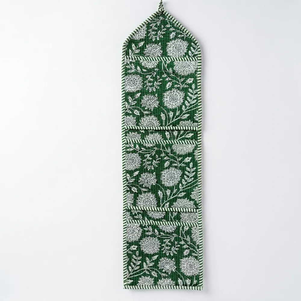 Close-up of the handcrafted green botanical print detailing, dense quilted stitching texture lines, robust pocket seam attachments, and clean pocket opening on the cotton pocket storage.