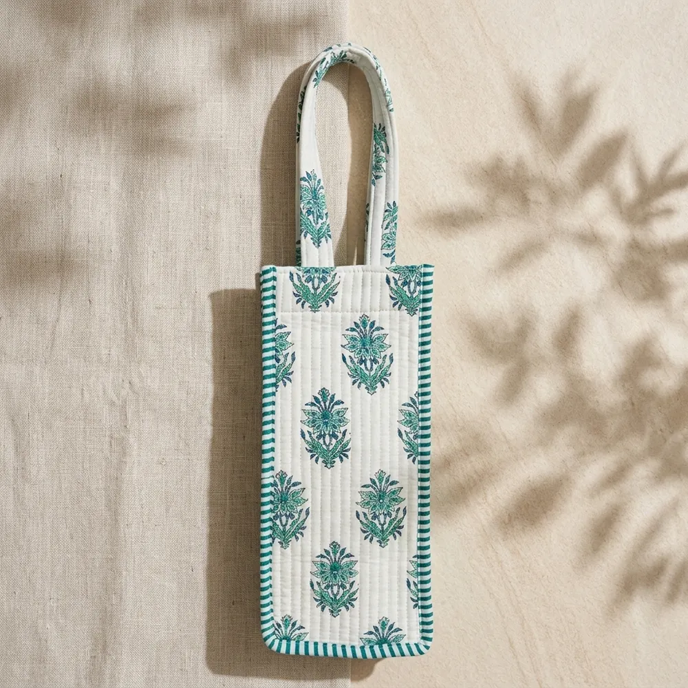 Close-up of the handcrafted green botanical block print detailing, dense quilted tracking lines, and reinforced handle base joints on the cotton wine holder.