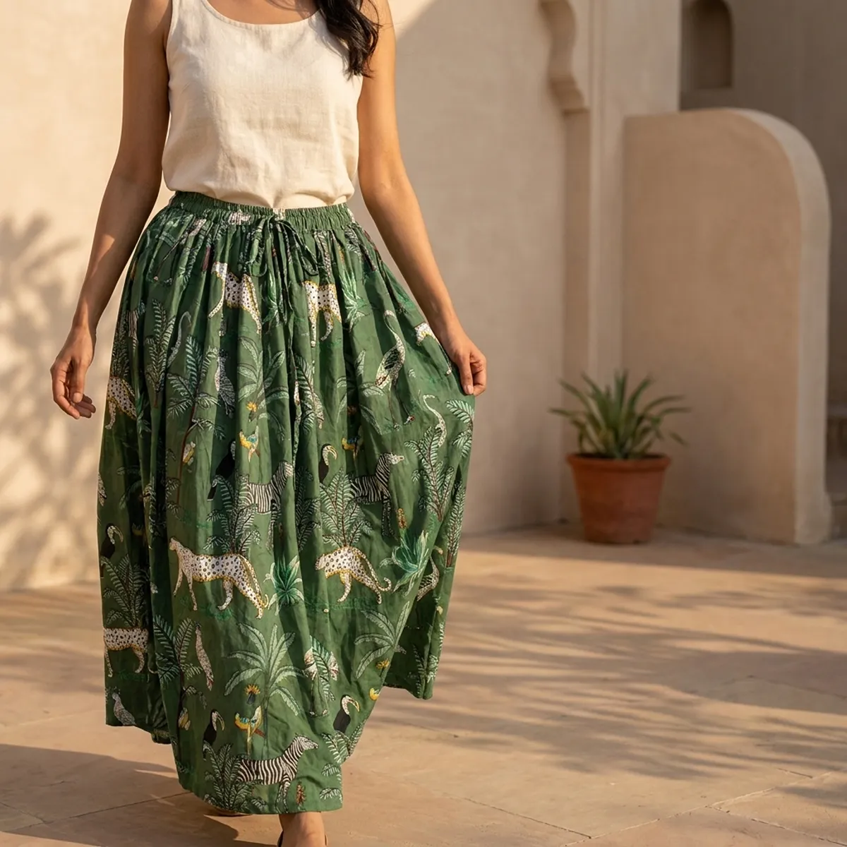 Green Safari Printed Cotton Maxi Skirt displaying the flowing flared silhouette and handcrafted exotic wilderness block print pattern on an outdoor model.