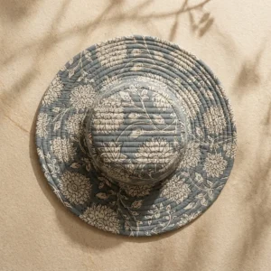 Close-up of the handcrafted grey floral print detailing, dense quilted tracking stitching lines, and neat edge trim on the reversible side of the summer travel headwear.