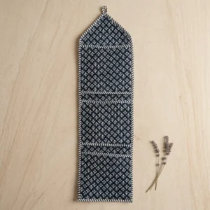 Close-up of the handcrafted indigo blue pattern detailing, dense quilted stitching texture lines, robust pocket seam attachments, and clean pocket opening on the cotton pocket storage.