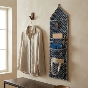 Close-up of the handcrafted indigo blue pattern detailing, dense quilted stitching texture lines, robust pocket seam attachments, and clean pocket opening on the cotton pocket storage.