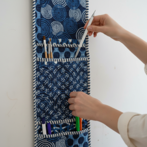 Close-up of the handcrafted deep blue geometric pattern detailing, soft quilted construction lines, heavy-duty stitching borders, and clean empty pocket entry slot on an Indian cotton wall organizer.
