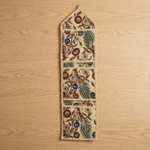 Close-up of the handcrafted Kalamkari avian print detailing, dense quilted stitching texture lines, robust pocket seam attachments, and clean pocket opening on the cotton pocket storage.