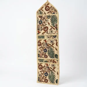 Close-up of the handcrafted Kalamkari avian print detailing, dense quilted stitching texture lines, robust pocket seam attachments, and clean pocket opening on the cotton pocket storage.