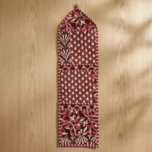 Close-up of the handcrafted maroon geometric print detailing, dense quilted stitching texture lines, robust pocket seam attachments, and clean pocket opening on the cotton pocket storage.