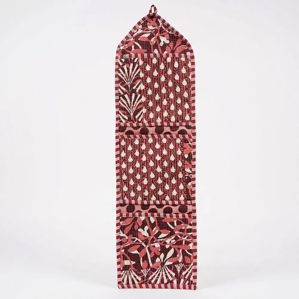 Close-up of the handcrafted maroon geometric print detailing, dense quilted stitching texture lines, robust pocket seam attachments, and clean pocket opening on the cotton pocket storage.
