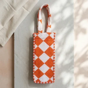 Close-up of the handcrafted orange geometric diamond block print detailing, dense quilted tracking lines, and reinforced handle base joints on the cotton wine holder.