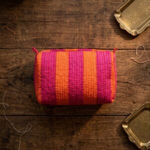Close-up of the largest case in the Orange Pink Striped Quilted Toiletry Bag Set opened to reveal the clean protective interior lining, smooth zipper track, and soft quilted horizontal stitching texture.