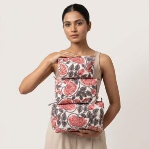 A traveler arranging the three pieces of the Pink Floral Quilted Toiletry Bag Set on a modern bathroom vanity counter, displaying the large, medium, and small sizes filled with cosmetic brushes and skincare bottles.